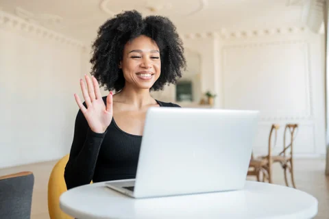 cheerful-woman-waving-hello-during-a-friendly-vide-2025-02-25-14-02-09-utc.JPG